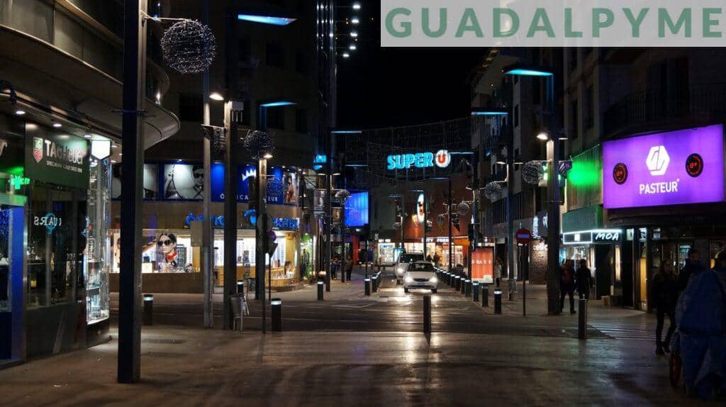 people walking on sidewalk during night time